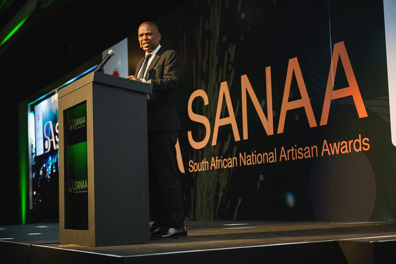 Senior official delivering a keynote address on stage