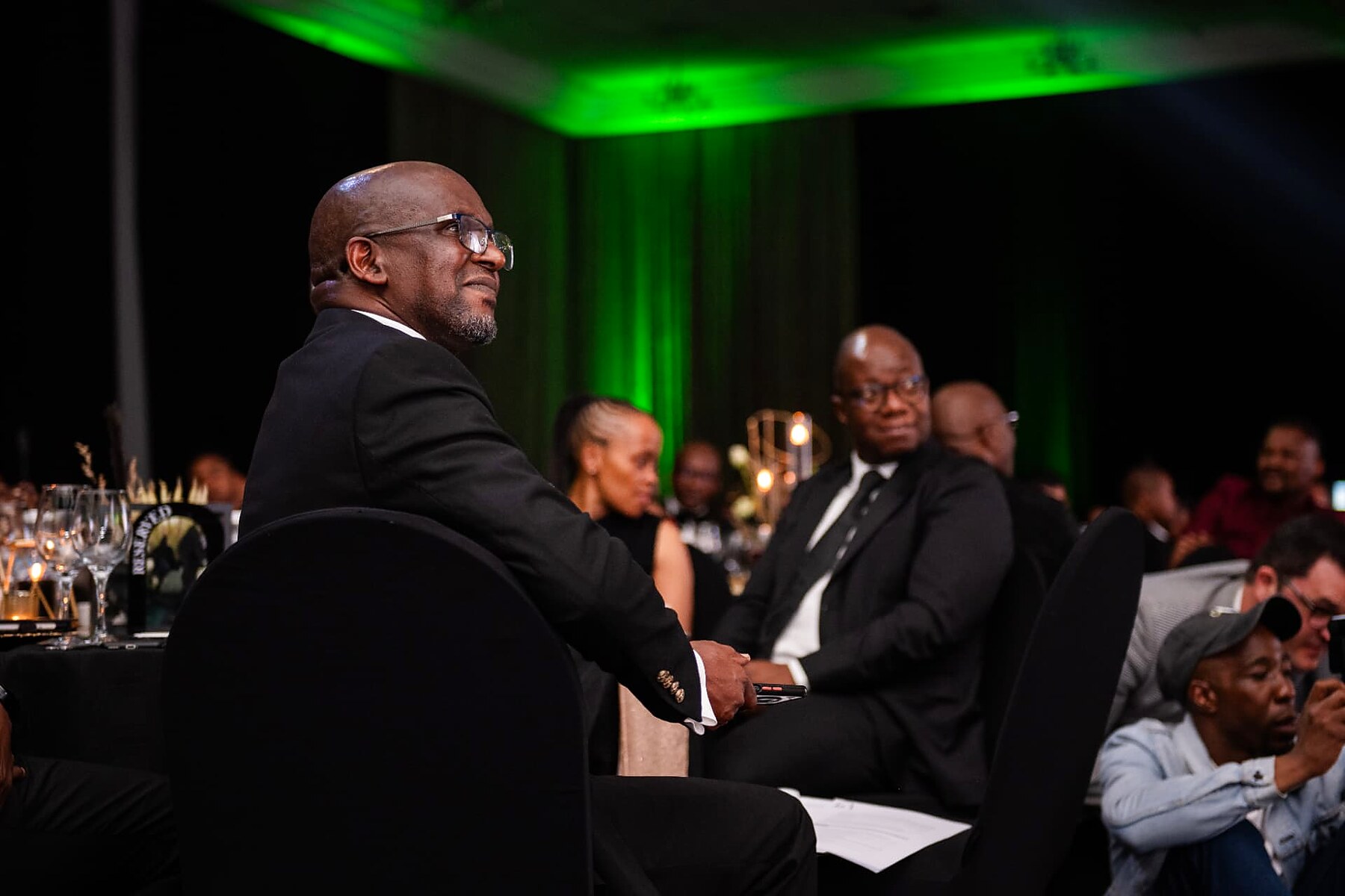 Guest watching the awards presentation from a reserved table