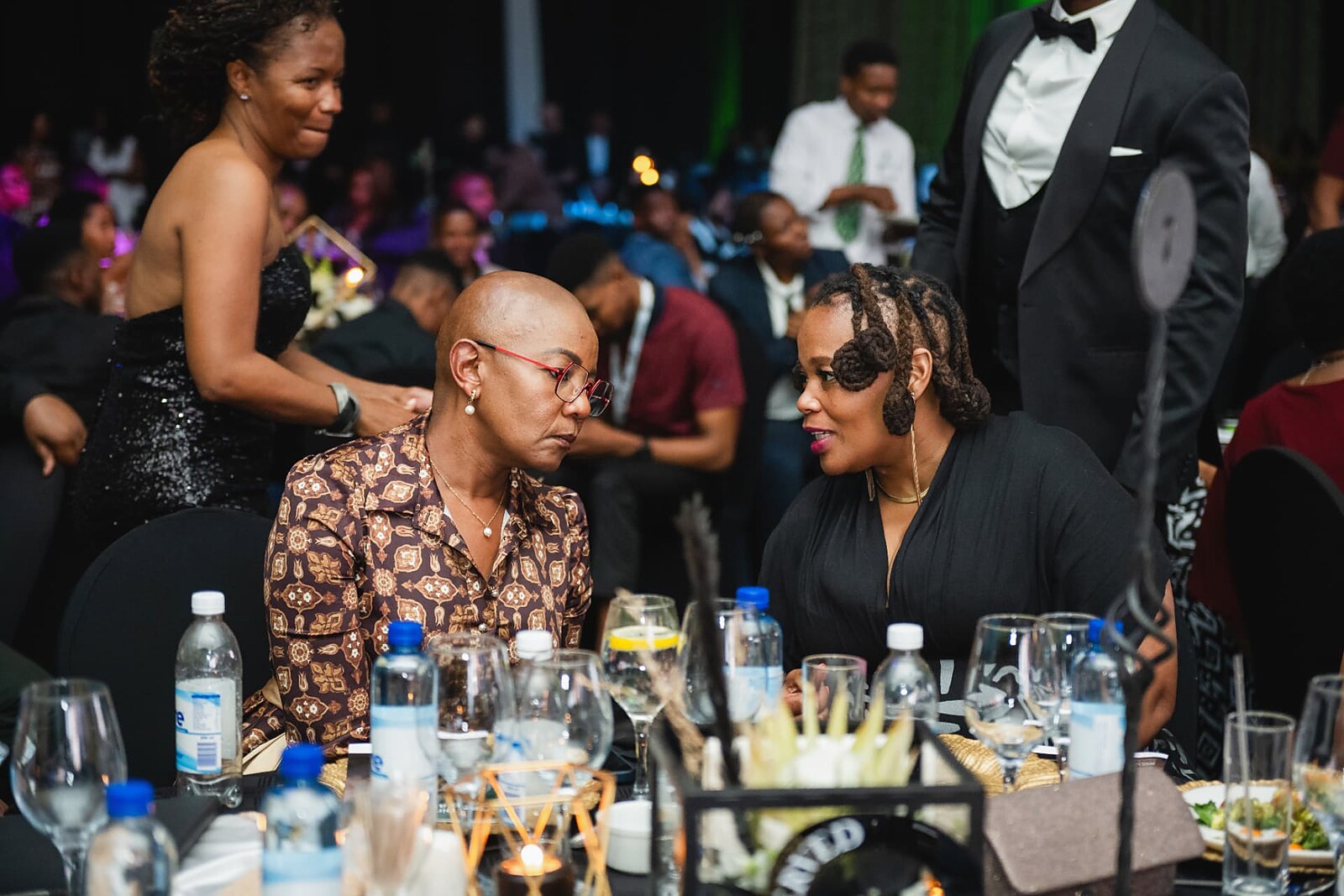 Two delegates in conversation at their table during dinner