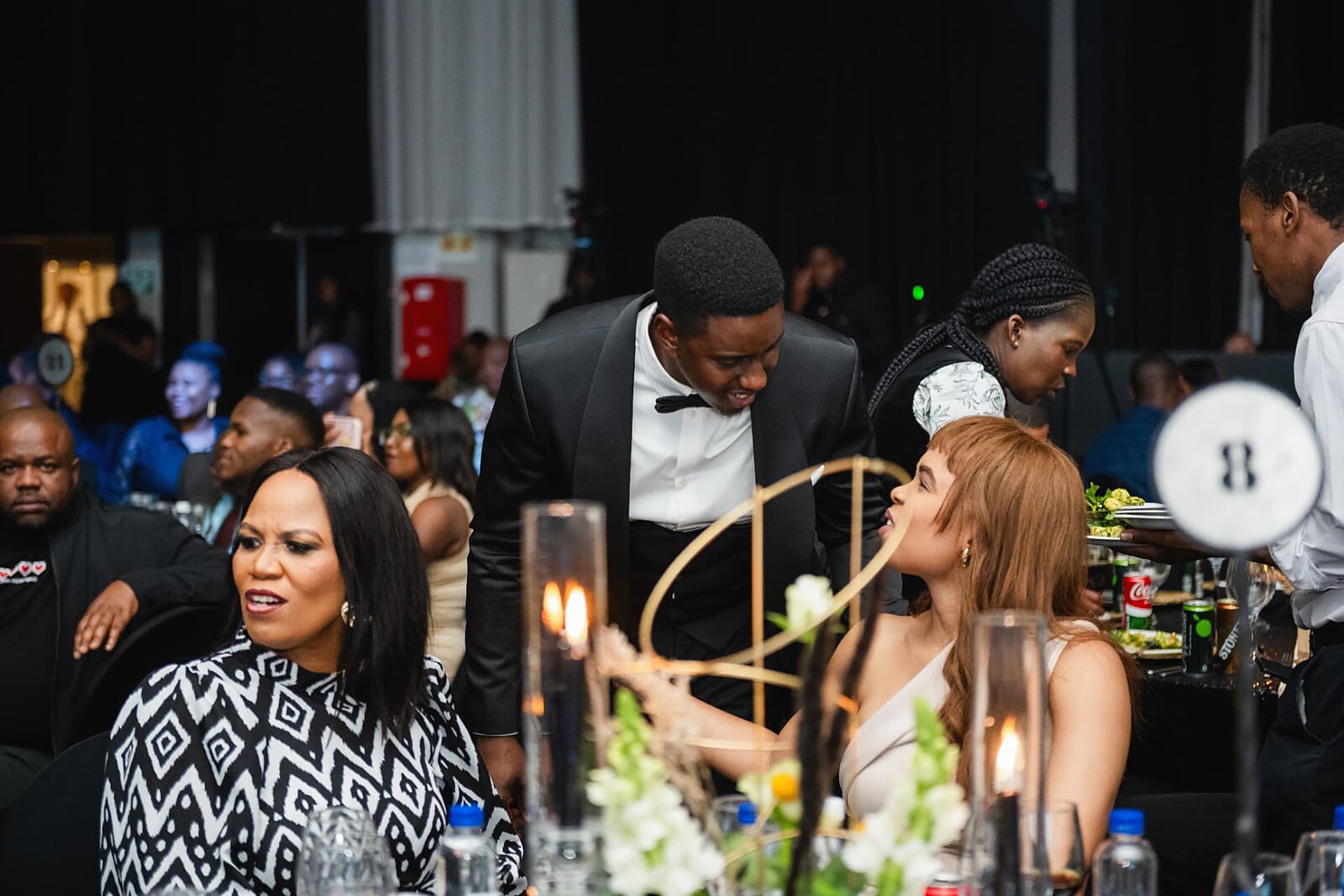 Guests chatting over the candlelit dinner service