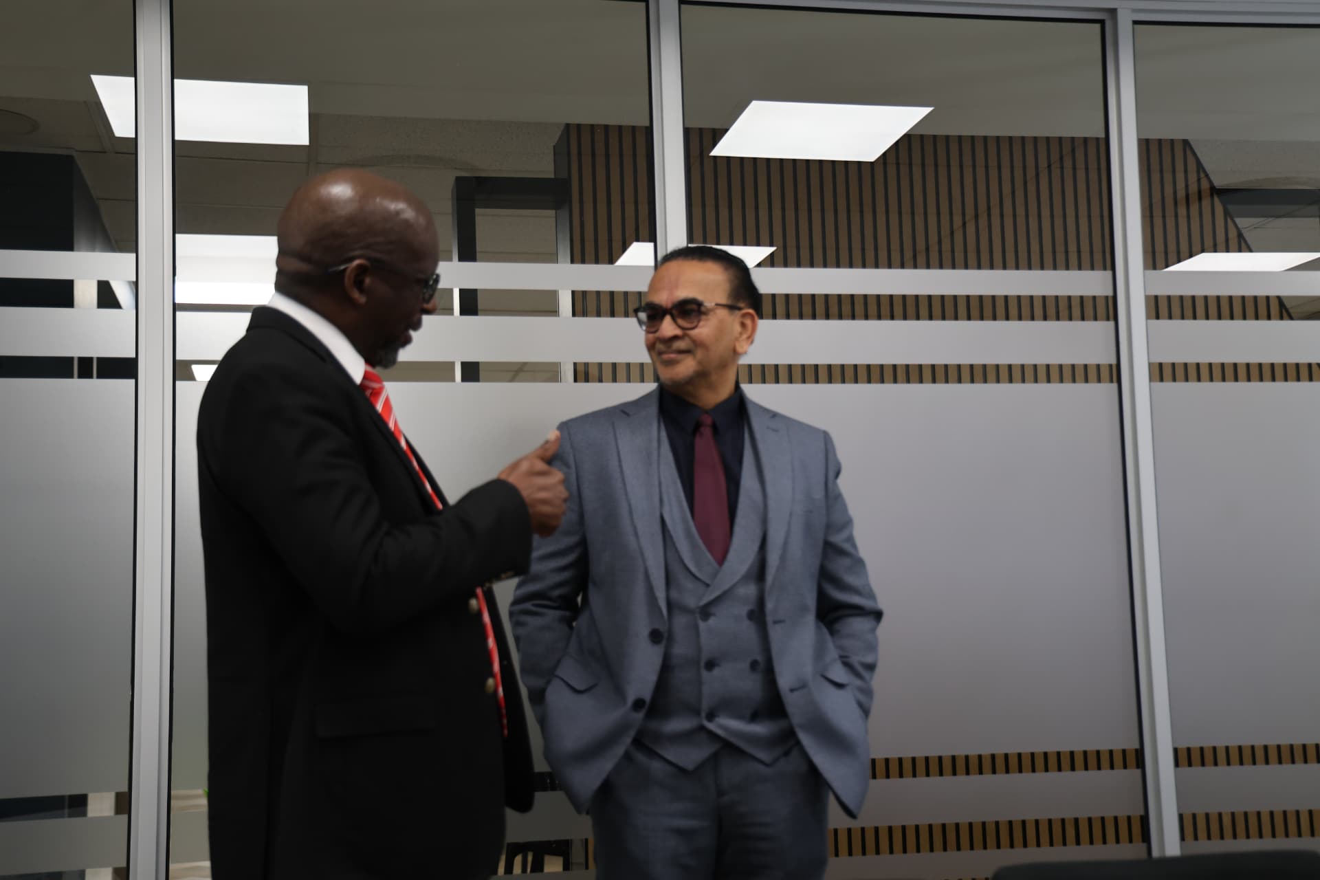 Two SANAA leaders sharing a light moment before the committee session