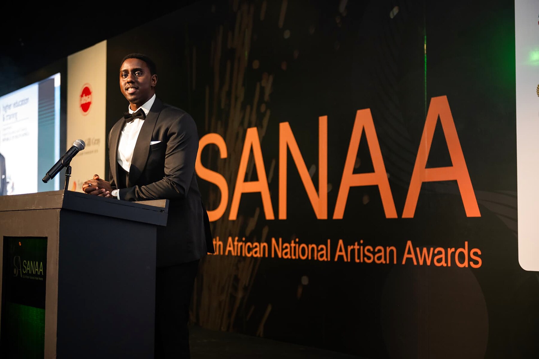 The programme director welcoming guests from the SANAA podium