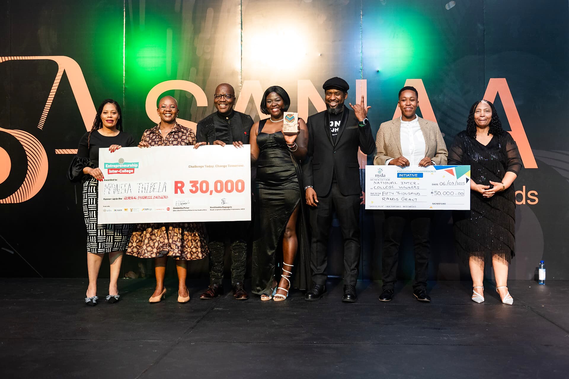 Winner of the general business category runner-up award holding a R30,000 cheque with officials and hosts