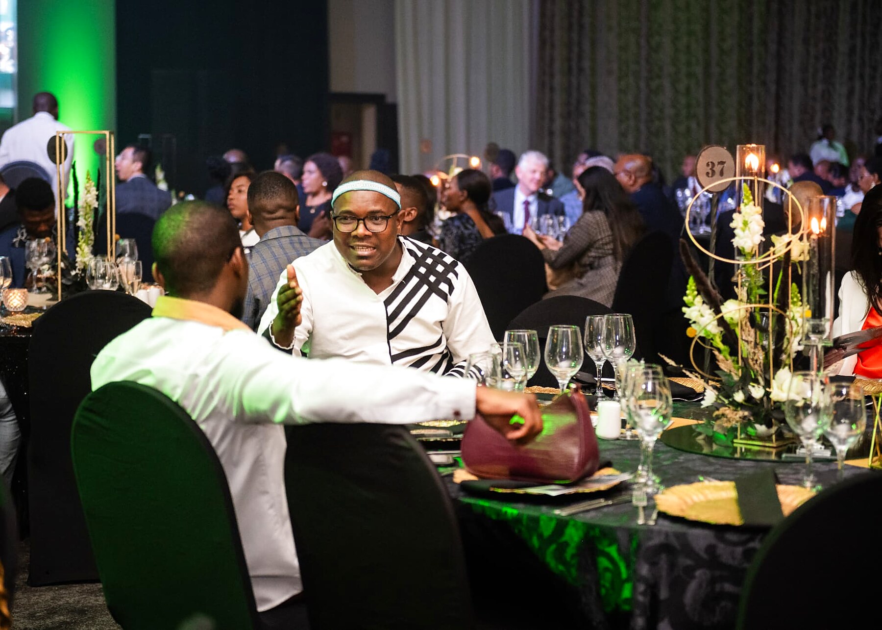 Guests greeting each other between tables at the SANAA 2026 gala