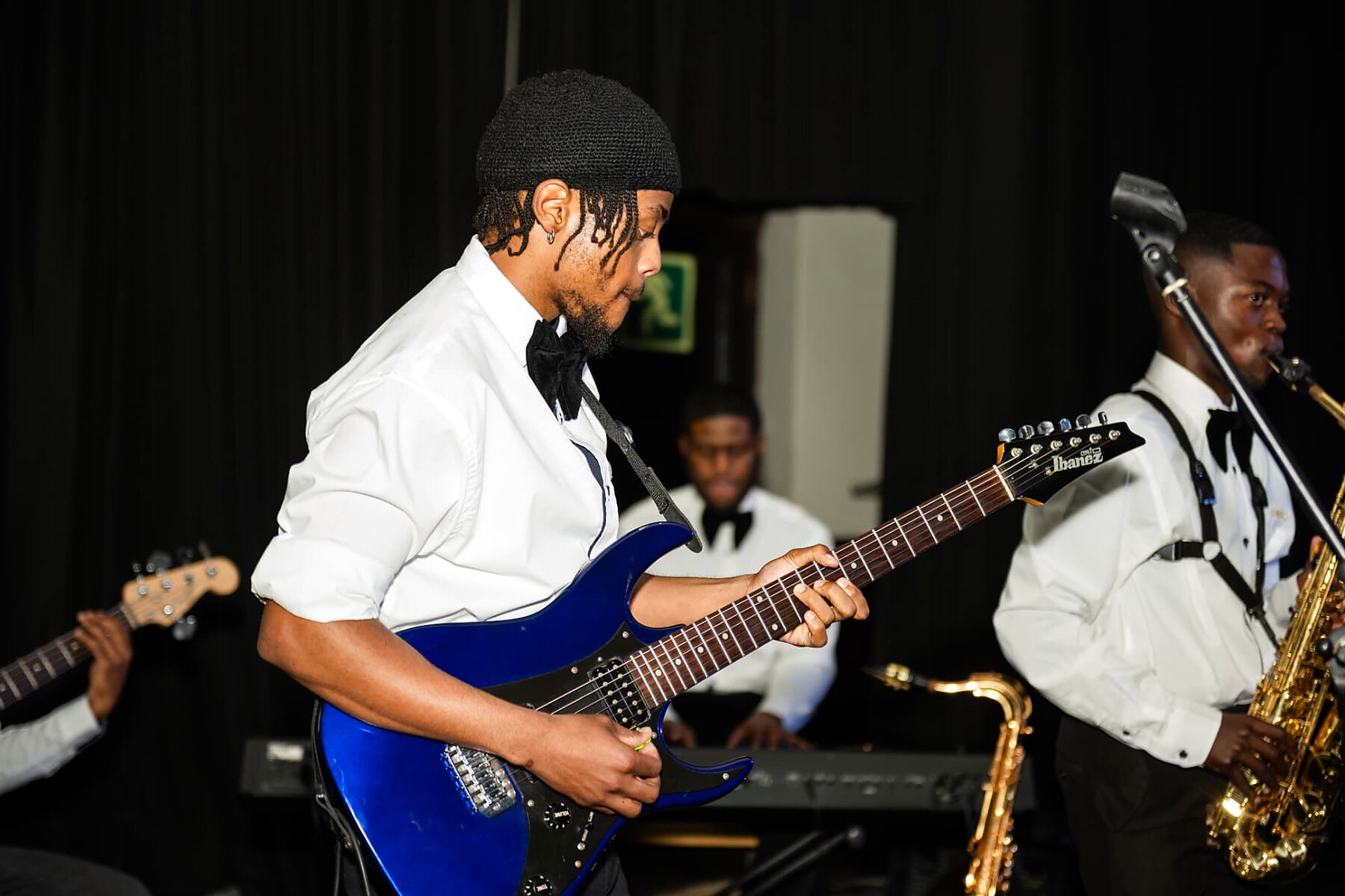 Guitarist performing with the live band at the SANAA 2026 gala