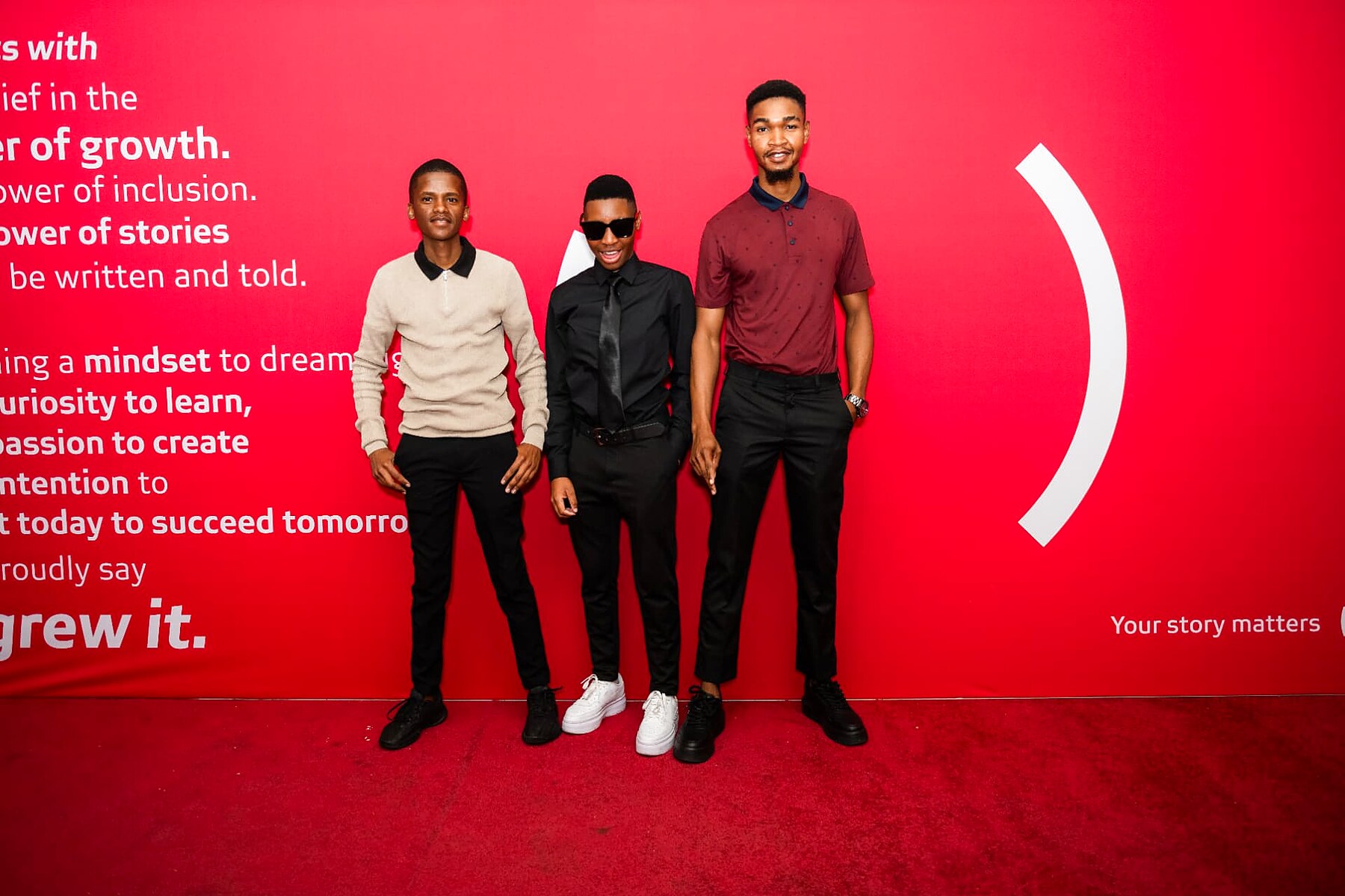 Three young nominees posing together on the SANAA 2026 red carpet