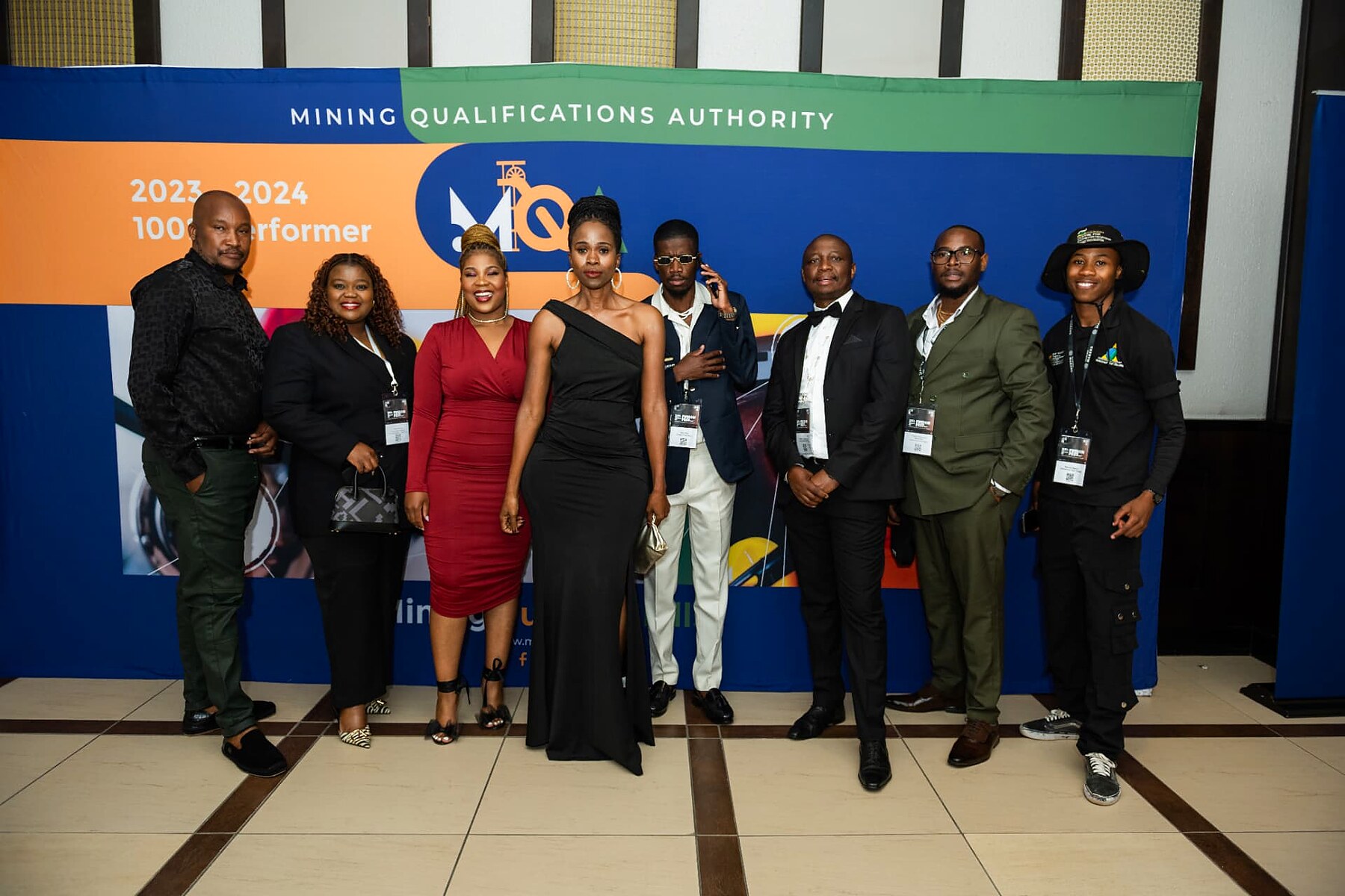 Delegates posing in front of the Mining Qualifications Authority partner banner