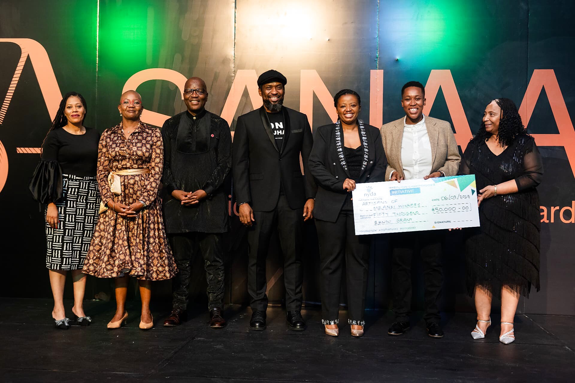 Artisans of Mzansi winners holding the NYDA R50,000 grant cheque with the SANAA leadership team