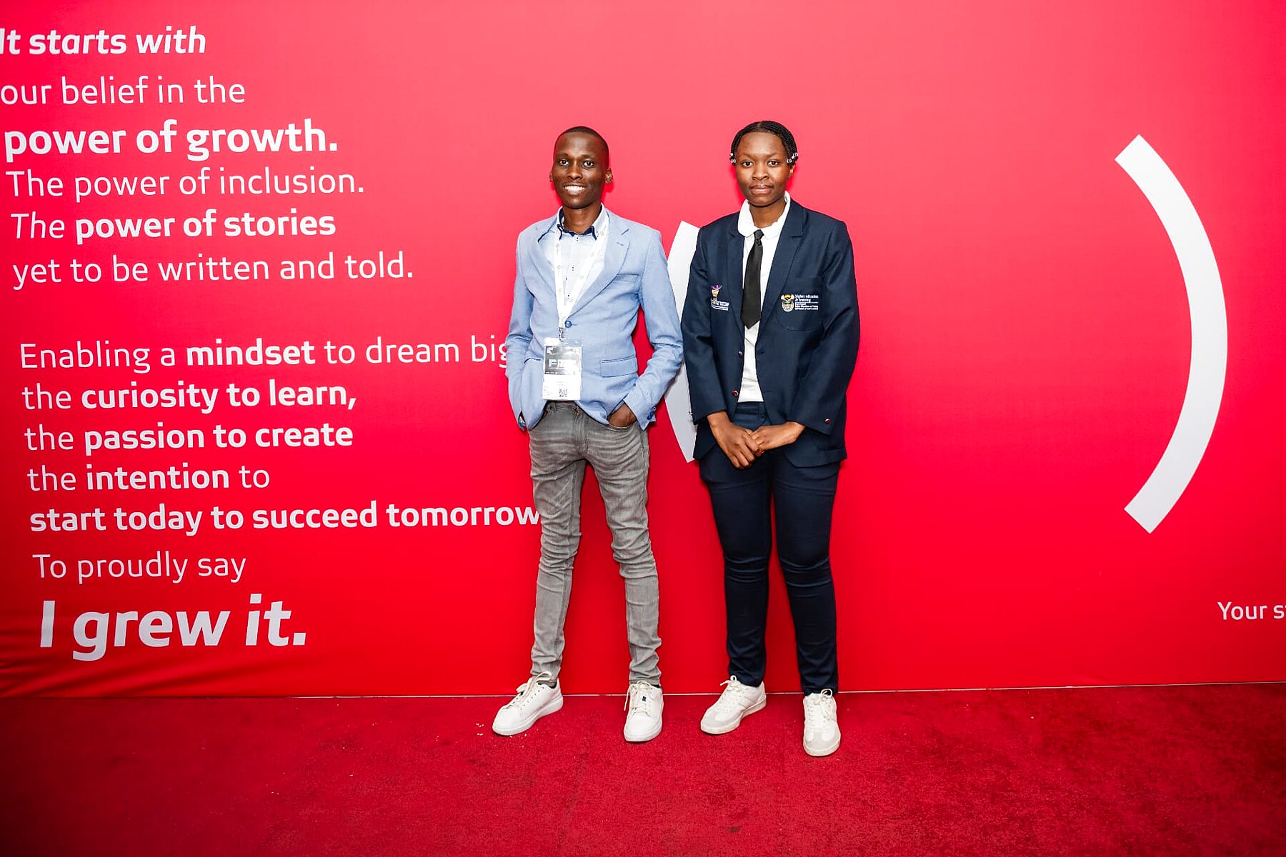 Two young TVET students posing on the SANAA 2026 red carpet at the sponsor wall