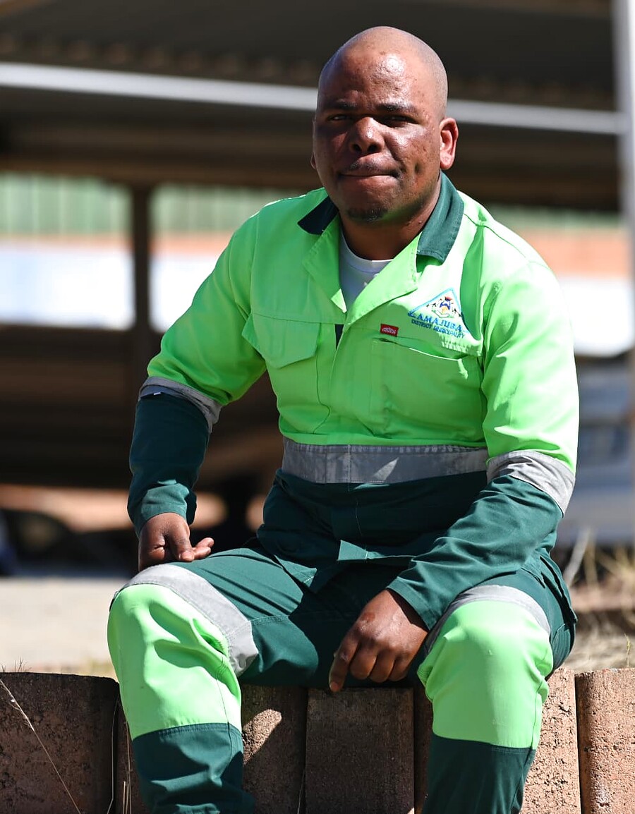SANAA 2026 KZN nominee in high-visibility green workwear seated outdoors at a training site