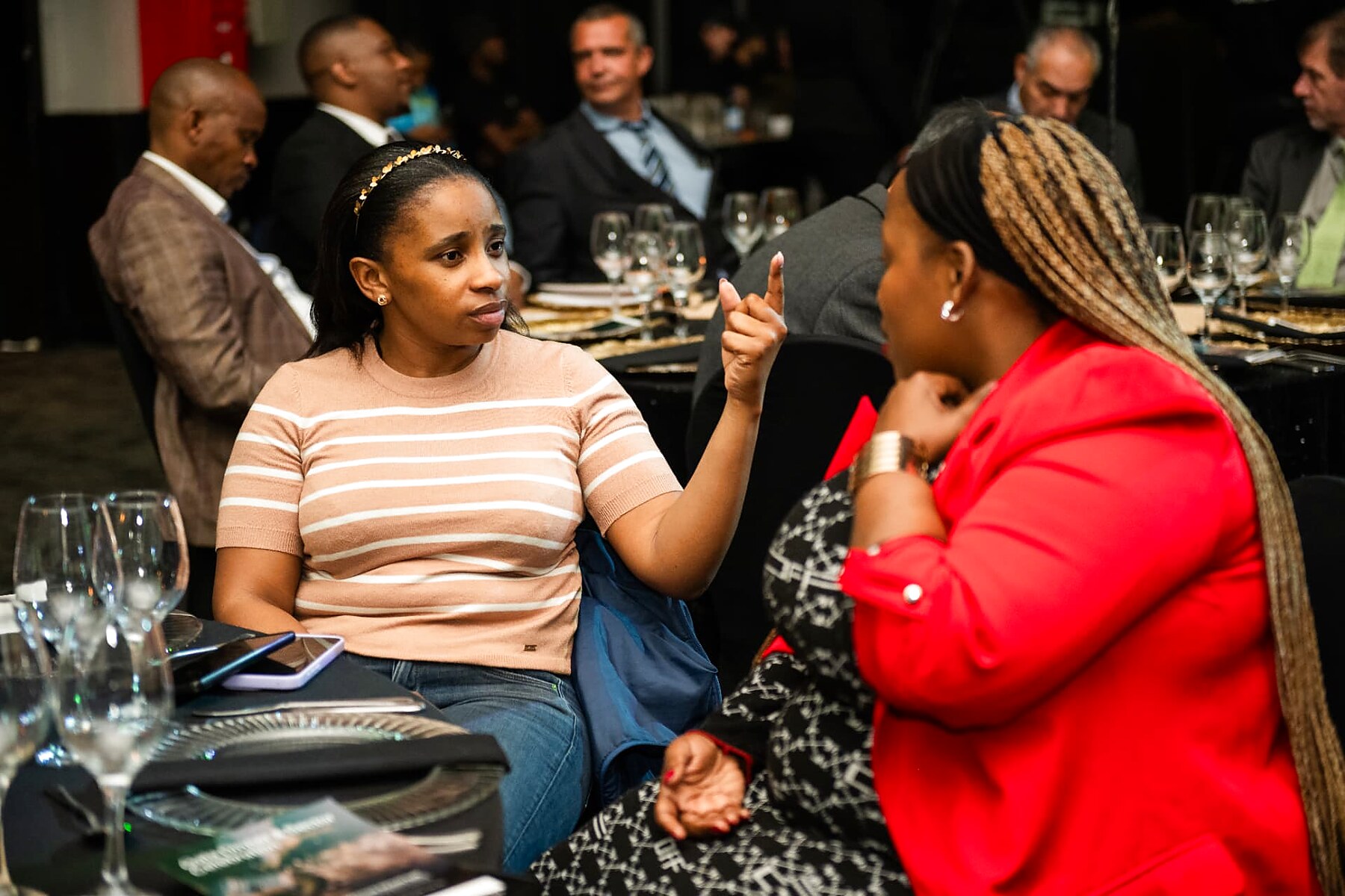 Two attendees deep in conversation during the gala dinner