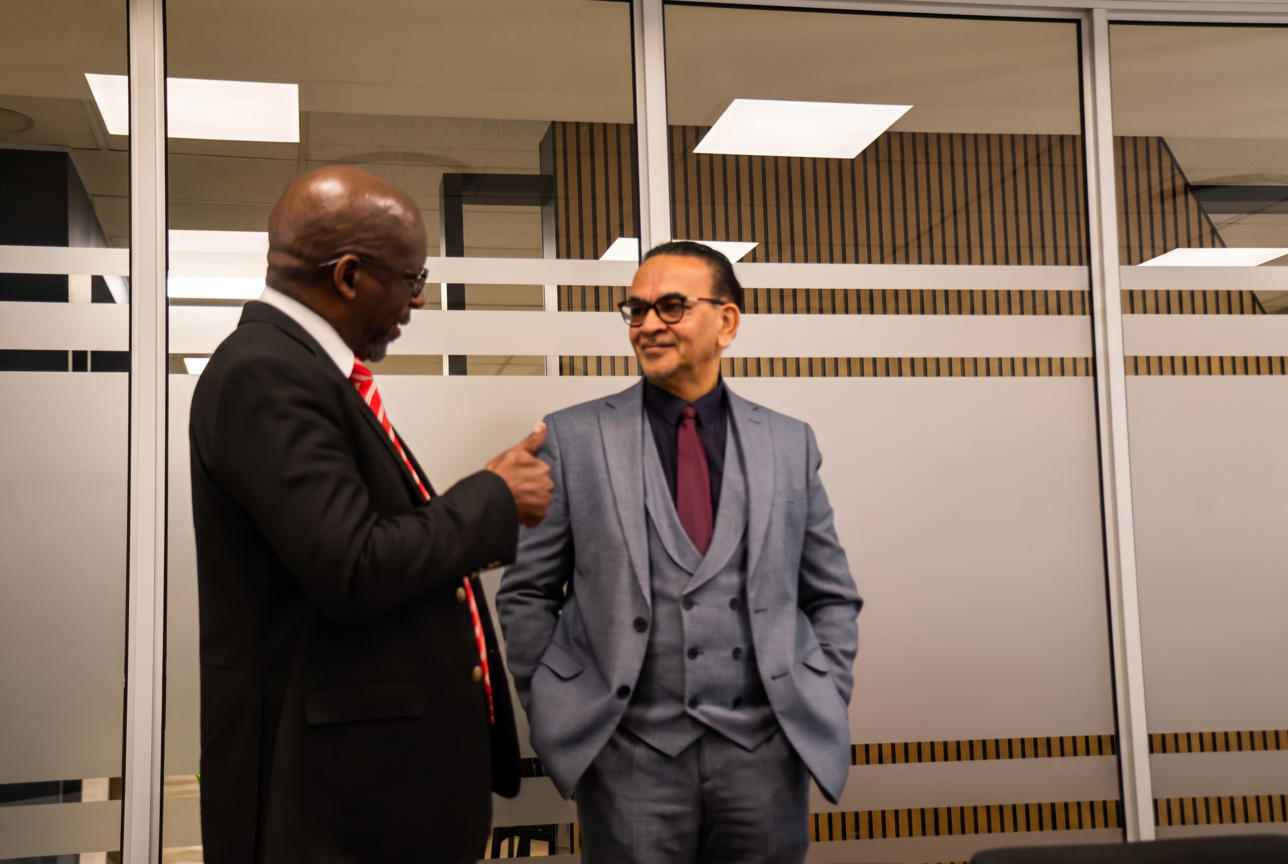 Two SANAA leaders sharing a light moment before the committee session