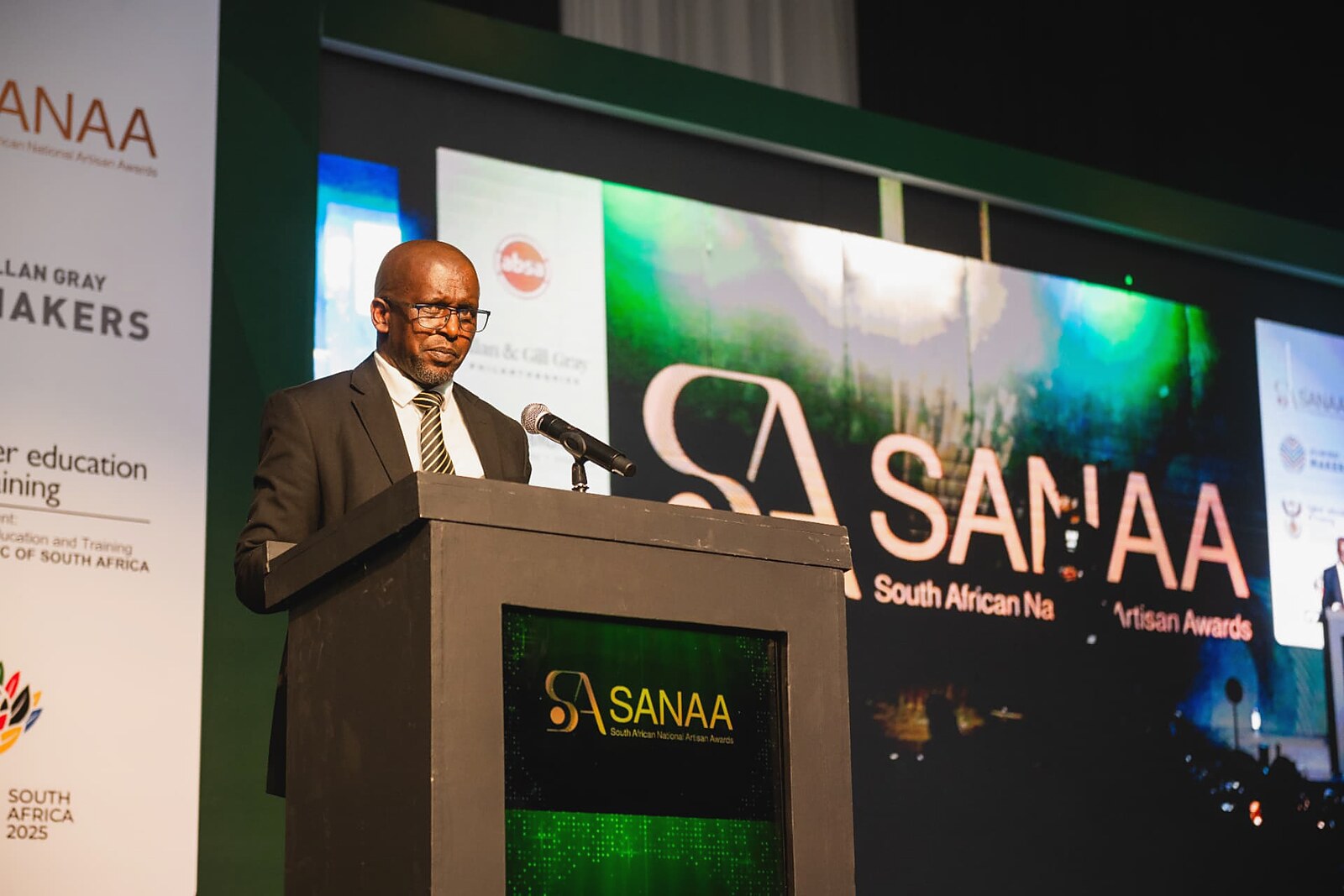 Senior official speaking at the SANAA podium