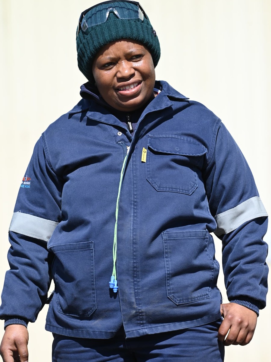 SANAA 2026 KZN nominee in navy blue work overalls with reflective strips and a green beanie