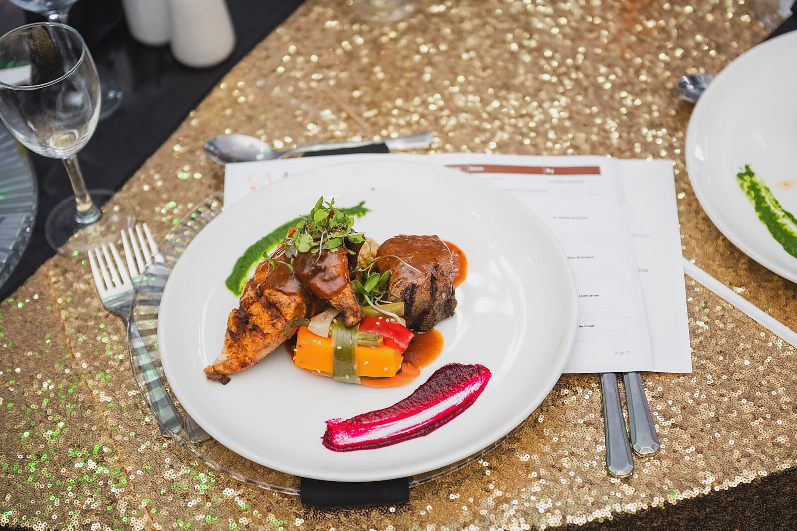 Plated main course served on the gold sequin table setting
