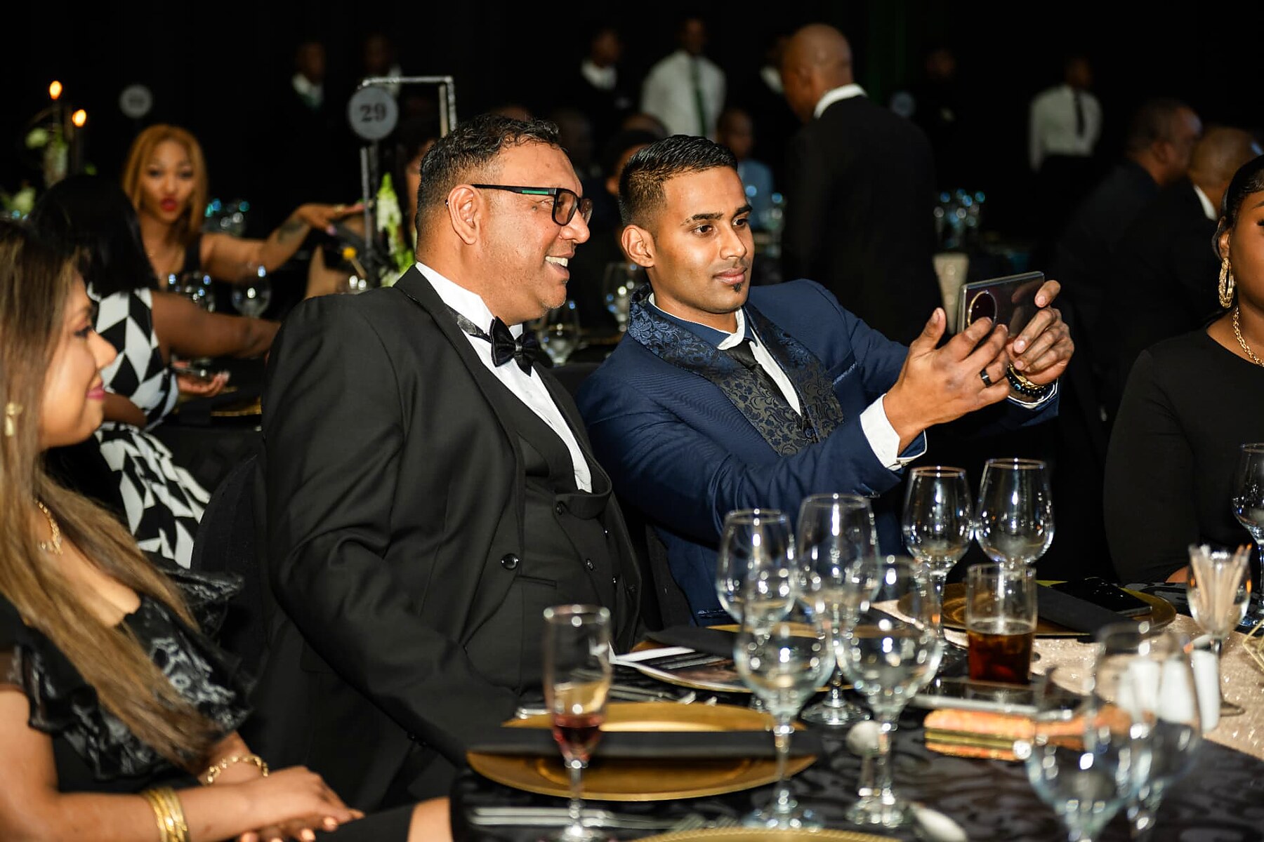 Guests taking a selfie at their table during the SANAA 2026 gala dinner