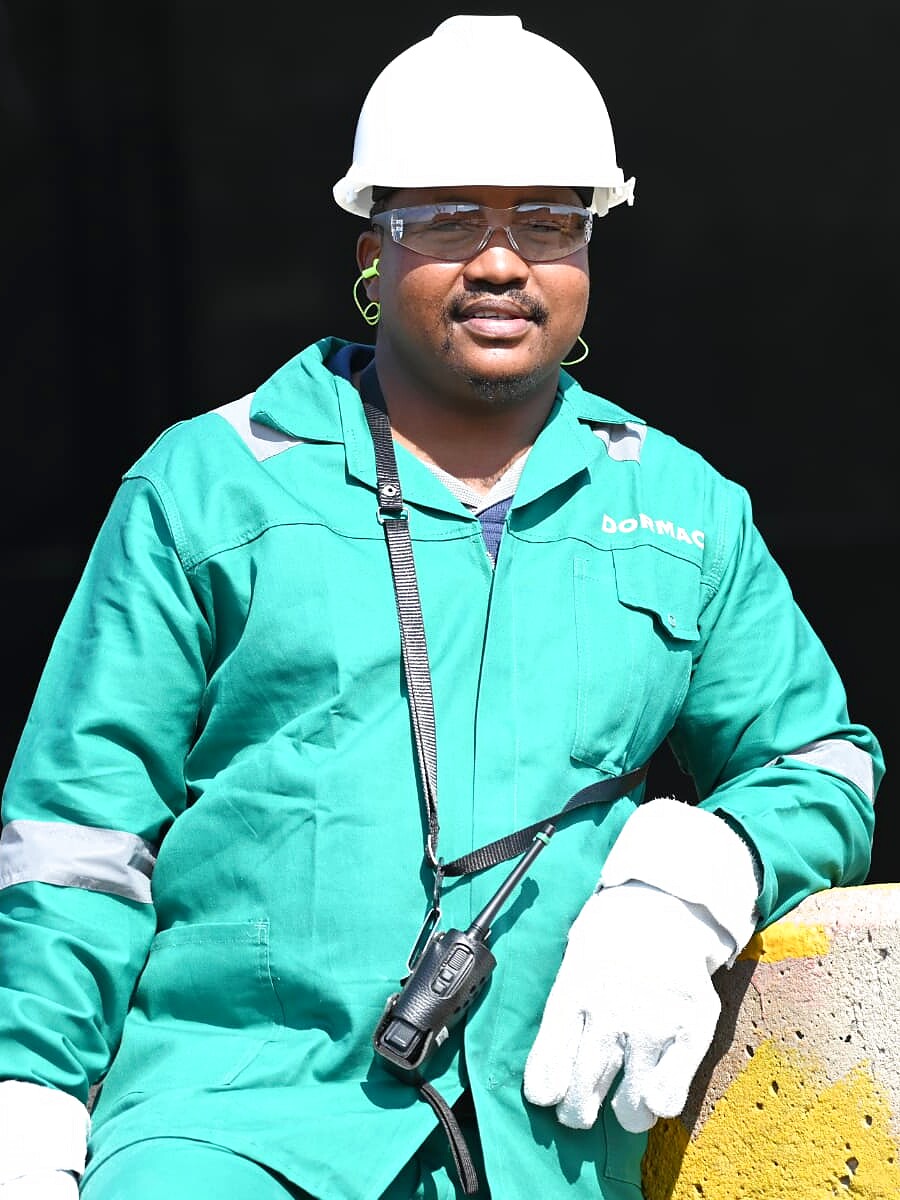 SANAA 2026 KZN nominee in teal DORMAC overalls and a white hard hat at an industrial site