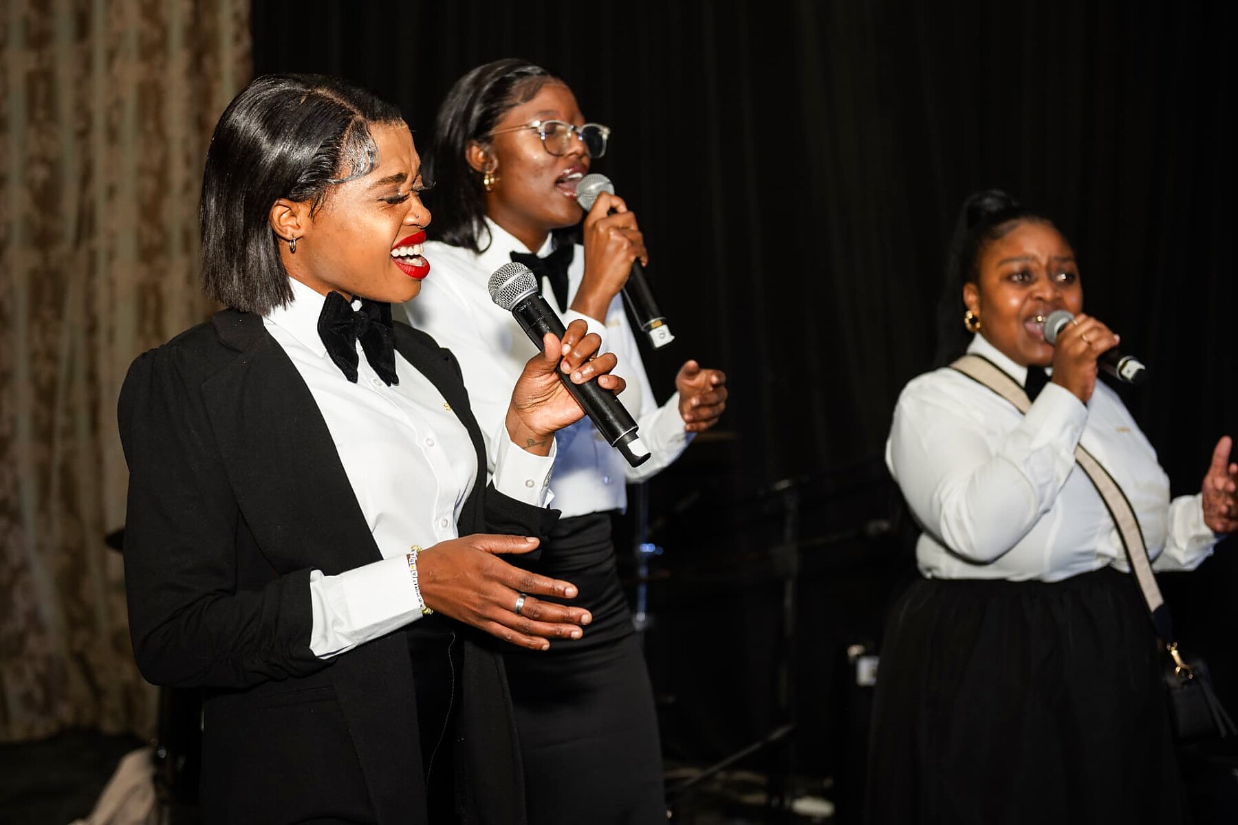 Vocal trio performing on stage at the SANAA 2026 gala evening