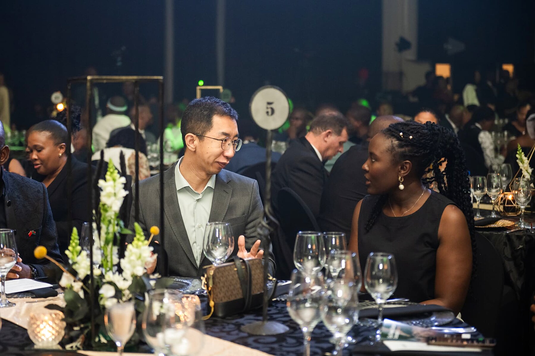 Two guests talking across the table during the SANAA 2026 gala evening