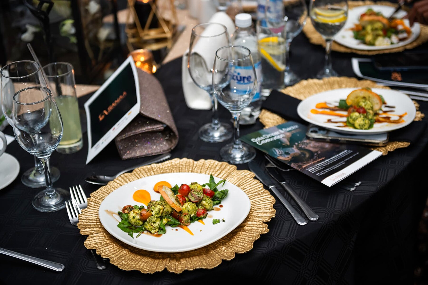 Plated starter course served on gold chargers at the SANAA gala dinner