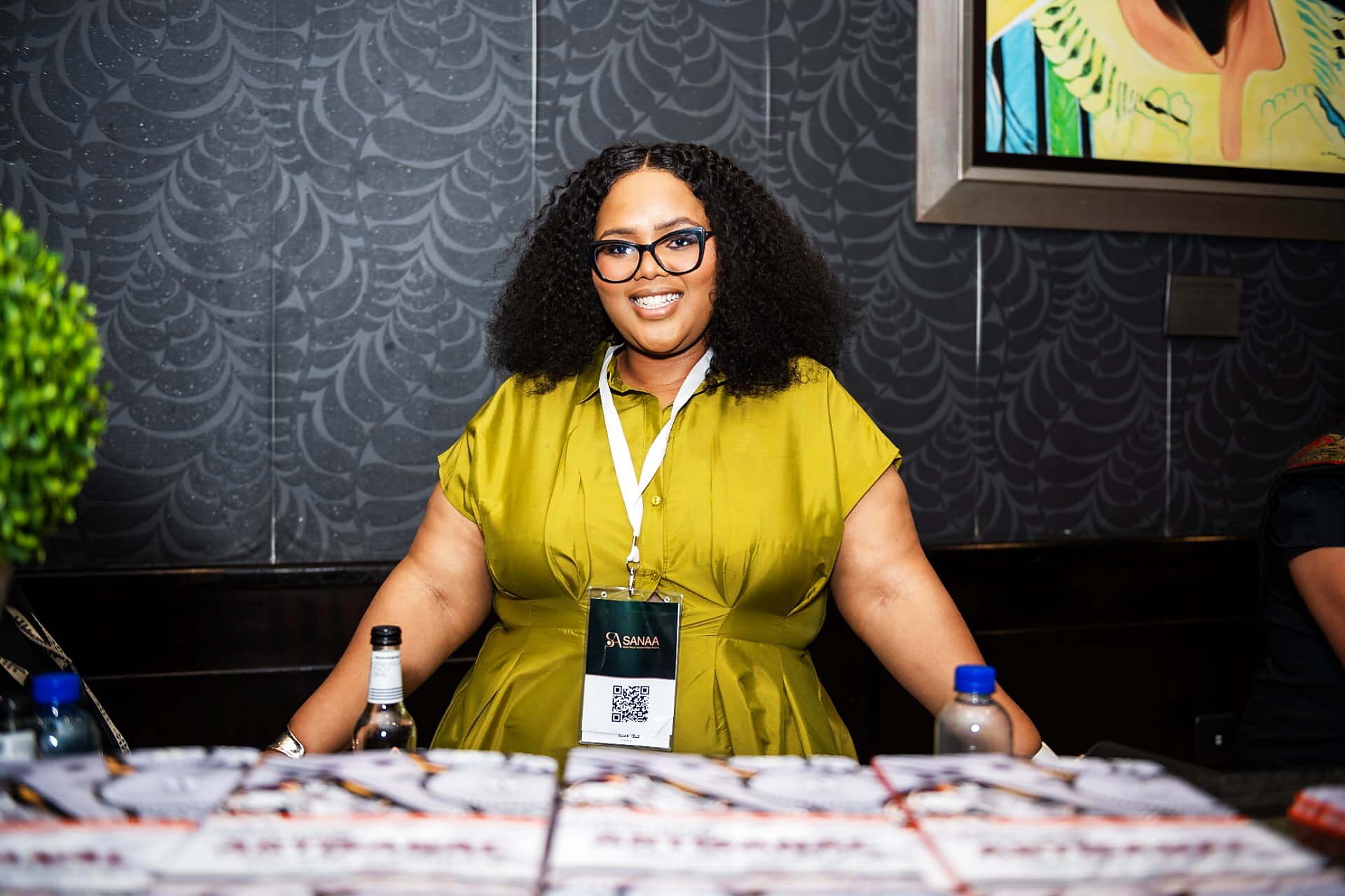 SANAA 2026 host welcoming guests at the registration desk with event programmes laid out