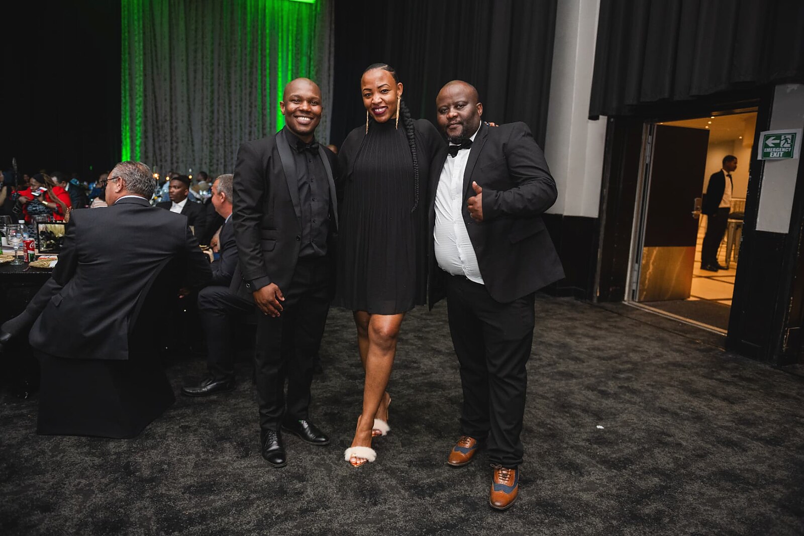 Three guests posing for a photo at the awards night
