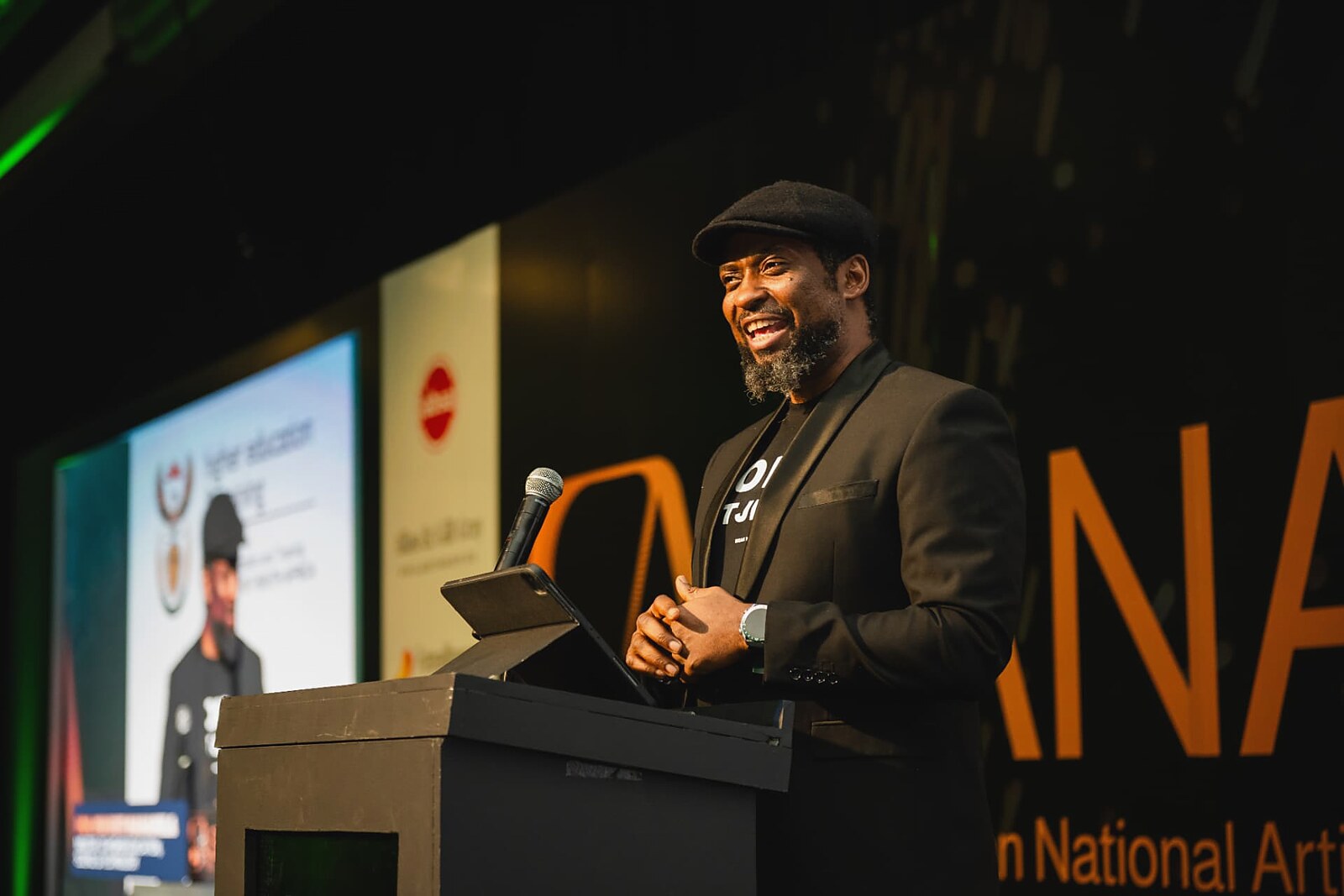 Master of ceremonies smiling while hosting the gala