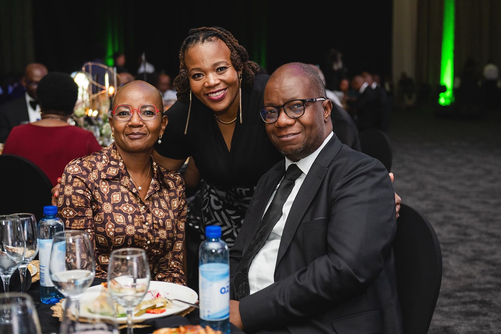 Guests posing for a photo at their dinner table