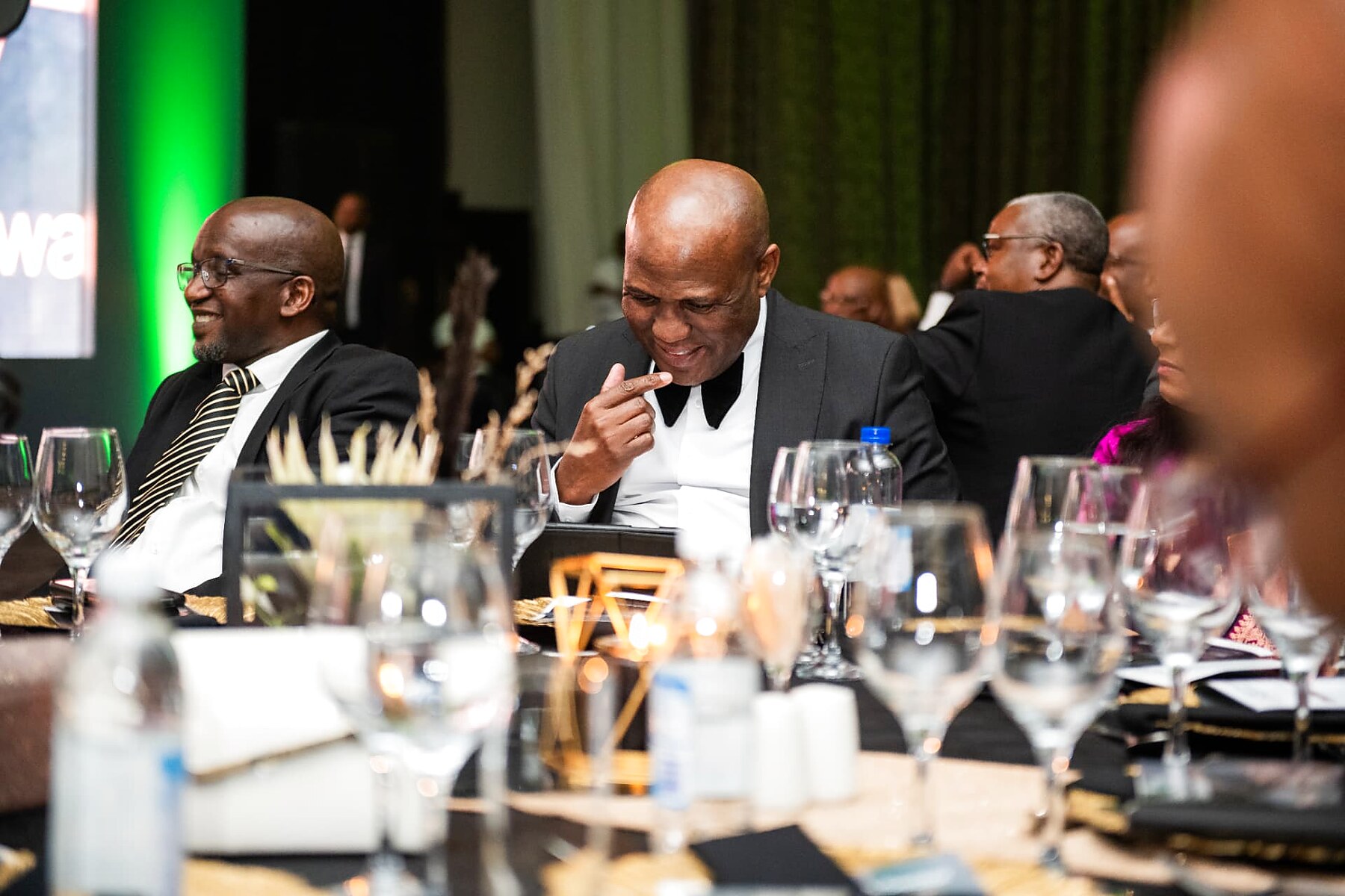 Two guests sharing a light moment during the awards programme