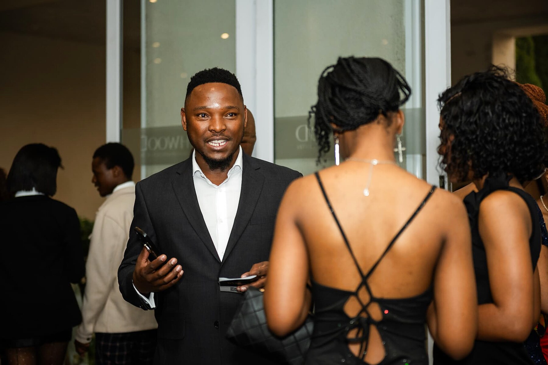 Smiling guest in a dark suit greeting fellow attendees at the SANAA 2026 gala